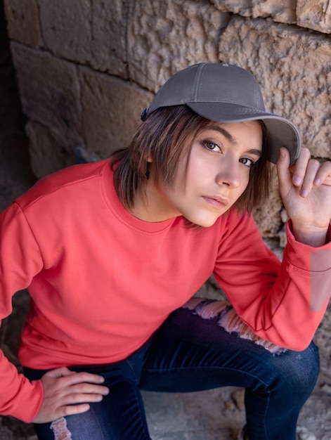 Teenager girl in grey baseball cap and pink long sleeve shirt outdoor mockup