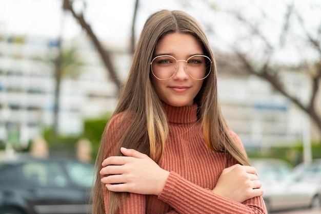 Teenager girl at outdoors freezing