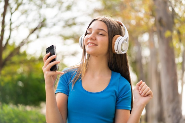 Teenager girl at outdoors using mobile phone