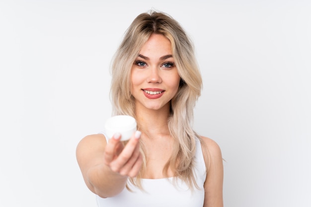 teenager girl with cosmetics over  wall