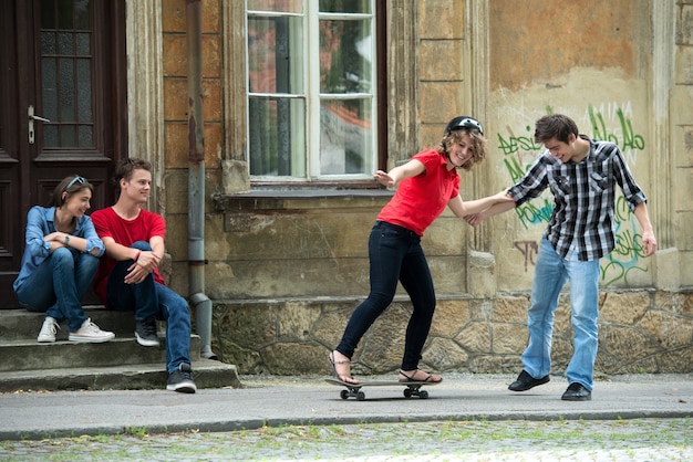 Teenager giving skateboarding lesson