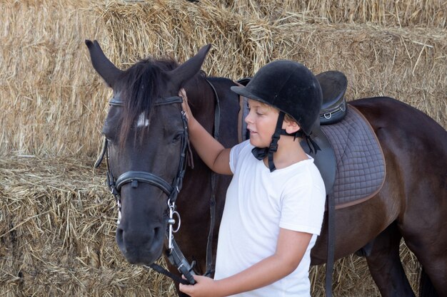 Teenager learning to ride in the riding school