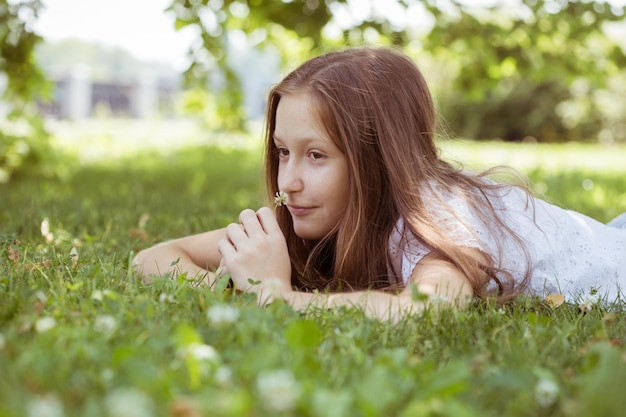 Teenager lies on a grass at the parkxA