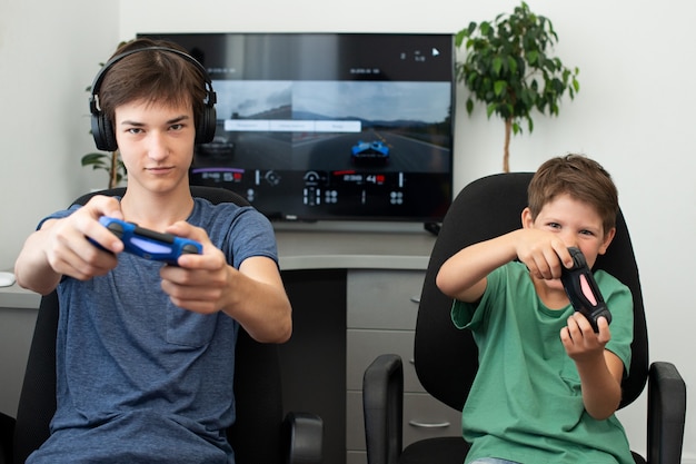 Teenager plays a  computer game with headphones and a joystick