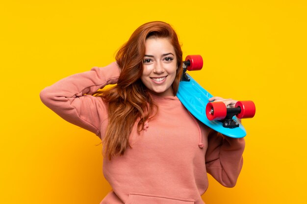 Teenager redhead girl with skate