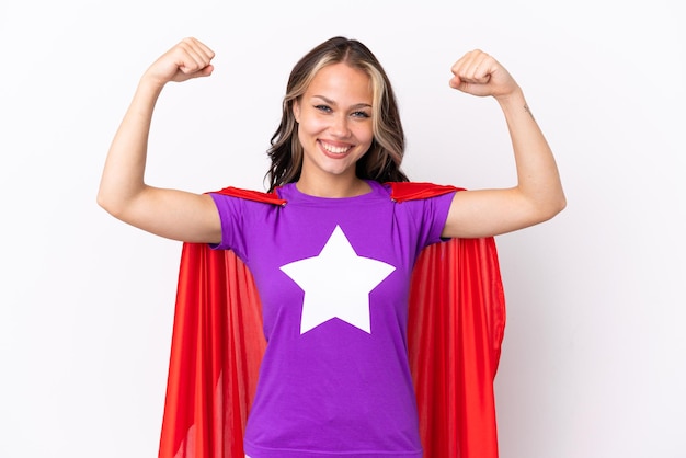 Teenager Russian girl isolated on white background in superhero costume and doing strong gesture