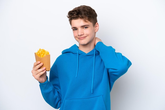 Teenager Russian man holding fried potatoes isolated on white background laughing