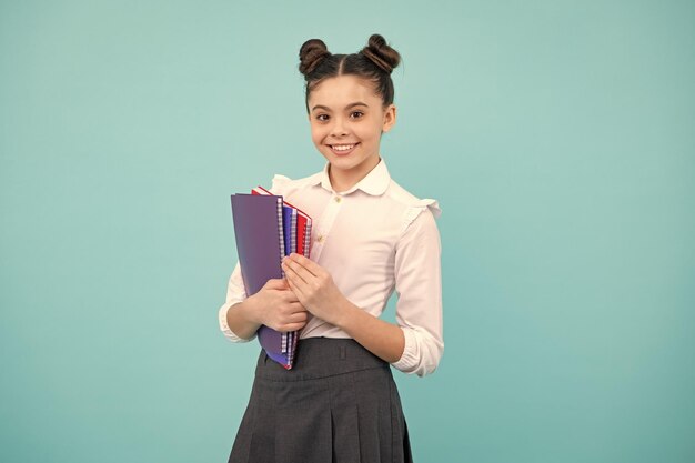 Teenager school girl with books isolated studio background Happy teenager positive and smiling emotions of teen girl