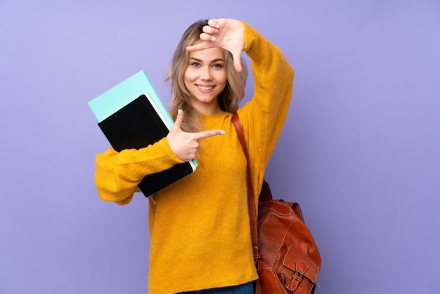 Teenager student girl isolated on purple