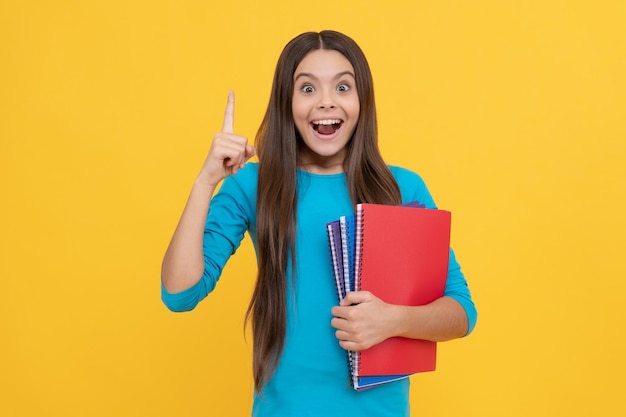 Teenager student inspired with idea Concept of education schoolgirl with copybook back to school teen girl ready for studying childhood happiness happy kid going to do homework with notepad