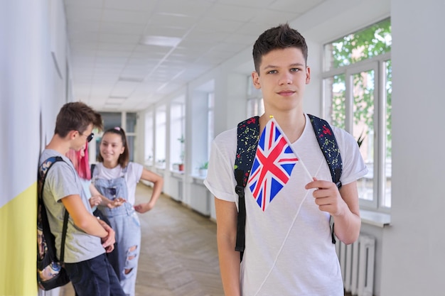 Teenager student with British flag school corridor group of students background UK Kingdom England school college education youth people concept