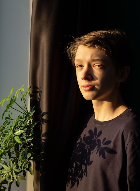 teenager at the window, pensive