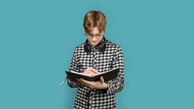 Teenager with red hair in a screeched shirt on a colored