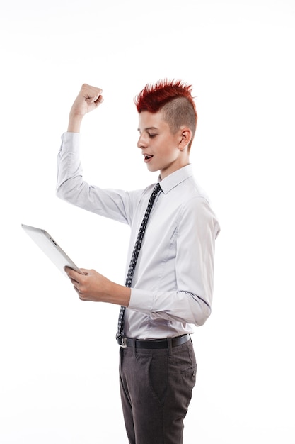 Teenager with tablet computer on white wall