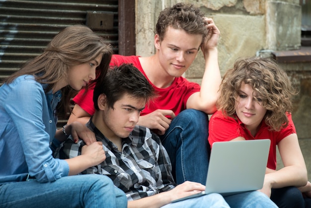 Teenagers reading on a tablet computer