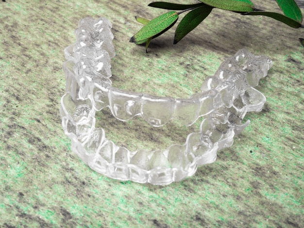 Teeth aligners Invisible aligner on green surface