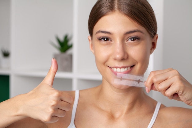 Teeth Whitening Beautiful Smiling Woman Holding Whitening Strip