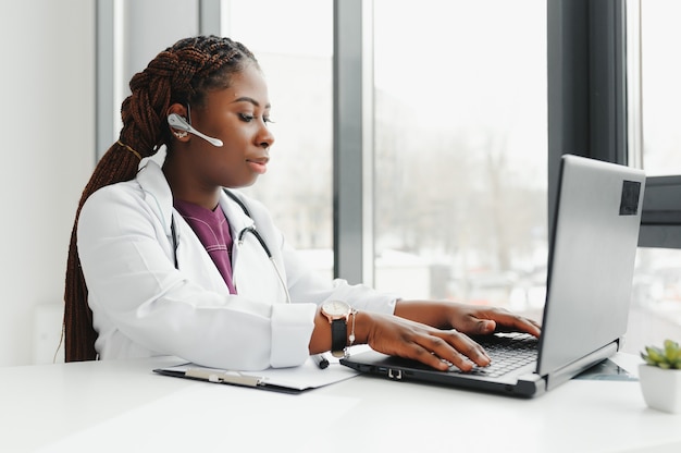 Telehealth, African American doctor in headset consulting