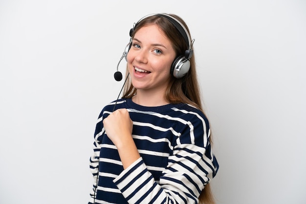 Telemarketer caucasian woman working with a headset isolated on white background celebrating a victory