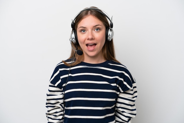 Telemarketer caucasian woman working with a headset isolated on white background with surprise facial expression