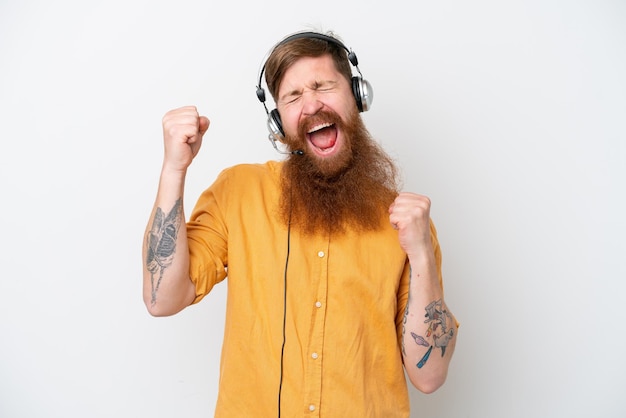 Telemarketer man isolated on white background celebrating a victory