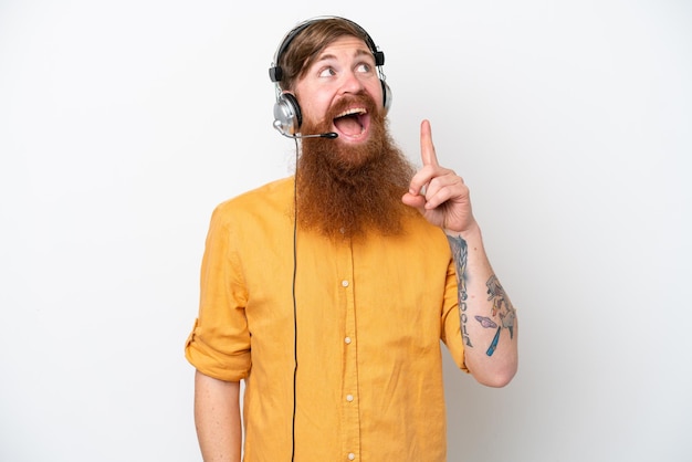 Telemarketer man isolated on white background pointing up and surprised