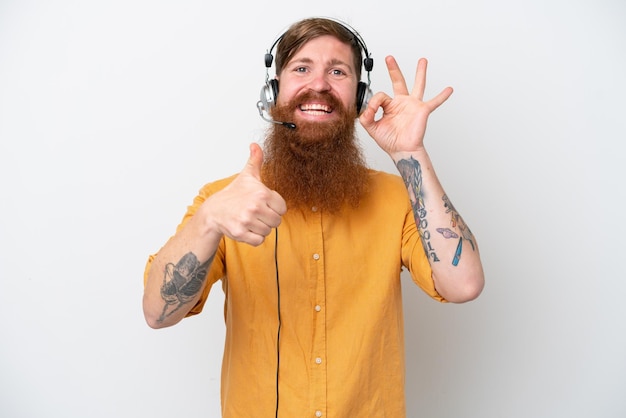 Telemarketer man isolated on white background showing ok sign and thumb up gesture