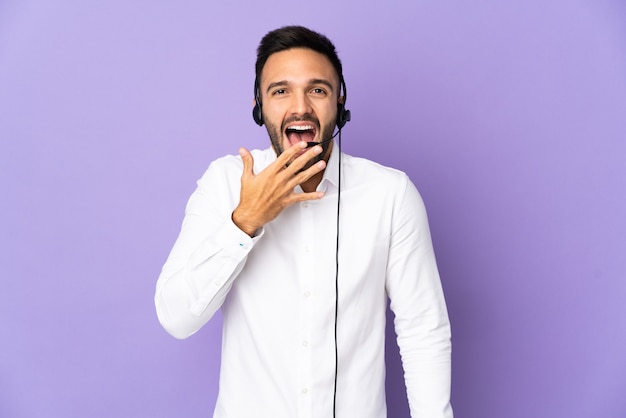 Telemarketer man working with a headset isolated