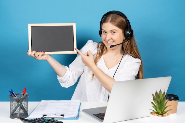 Telemarketing operator woman pointing at blackboard