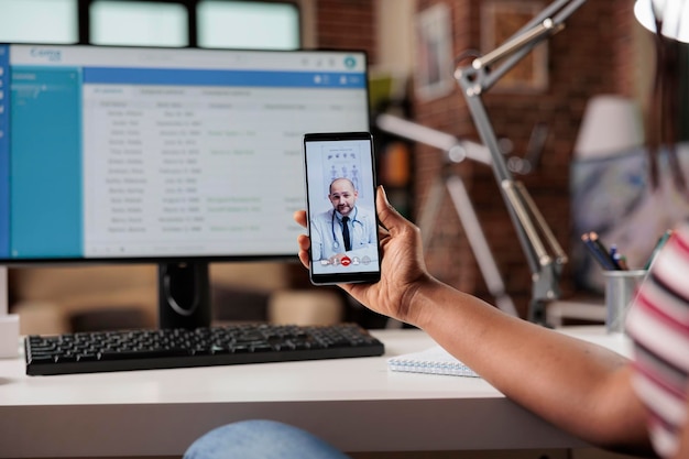 Photo telemedicine, online medical consultation, woman having live chat with therapist. patient talking with doctor on smartphone video call, general practitioner on mobile phone screen