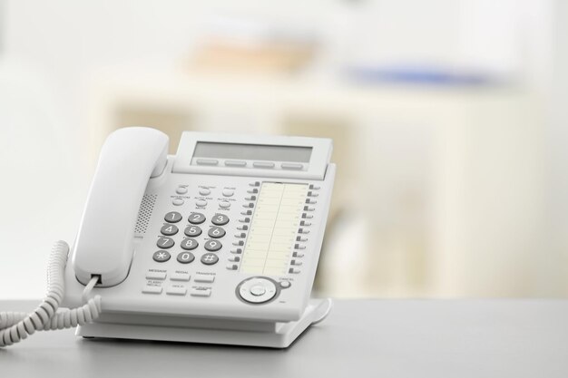 Telephone on table against blurred background