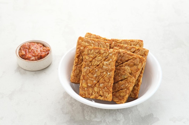 Tempeh, Tempe Goreng or Fried tempeh, Indonesia traditional food, served with sambal (chilli sauce)