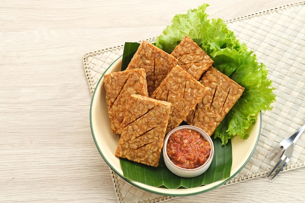 Tempeh, Tempe Goreng or Fried tempeh, Indonesia traditional food, served with sambal (chilli sauce)