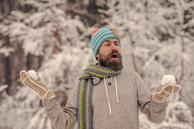 Temperature freezing cold snap bearded man with snowballs in snowy forest skincare beard care in win...