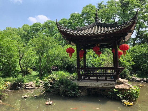 Temple by lake against trees