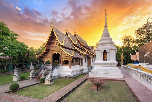 Temples against cloudy sky during sunset