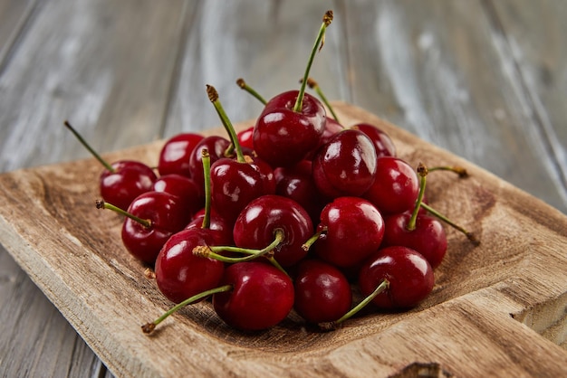 Tempting Harvest Juicy Cherries Overflow on Wooden Scoop Nature's Sweet Bounty