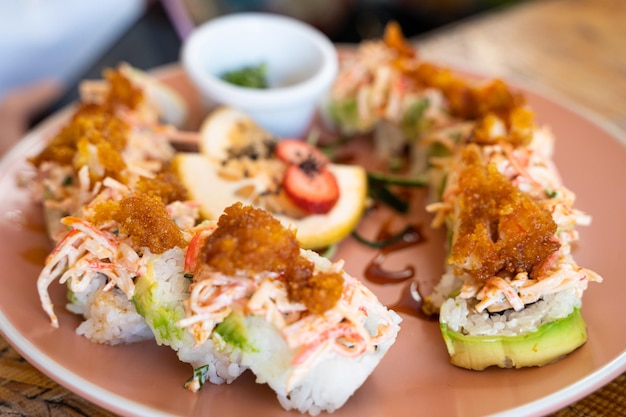 Tempura prawn sushi roll plate with crab stick. Traditional Japanese food by Mexican fusion concept