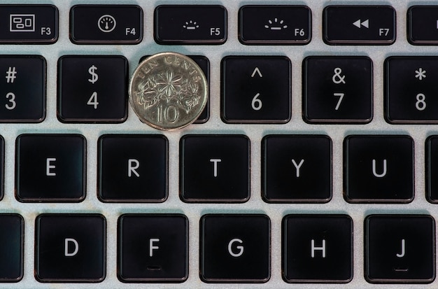 A ten cents Singapore coin on the computer keyboard