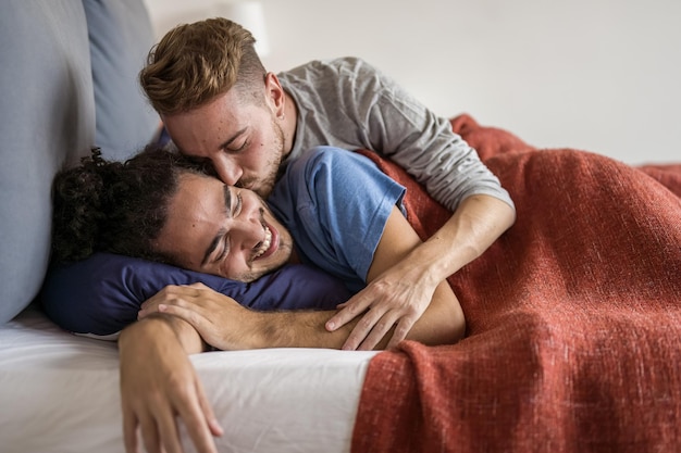 Tender awakening of a gay man kissing his boyfriend daily moments of a LGBT couple