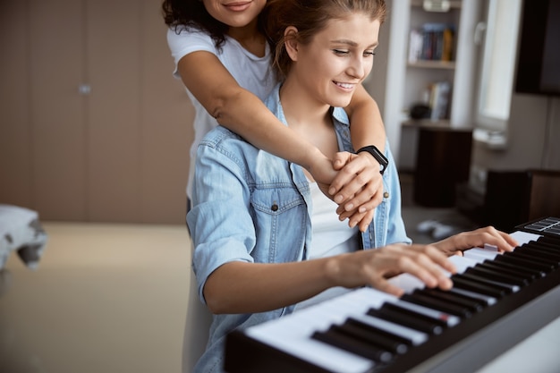 Tender brunette embracing her partner while listening to fantastic melody