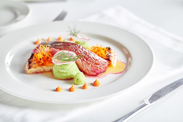 Tender dorado fillet with vegetables and basil Banquet festive dishes