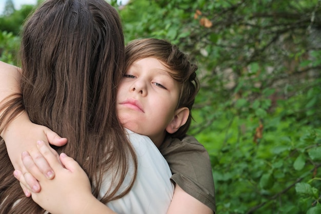 Photo a tender embrace as a mother comforts her upset son showcasing maternal support and a child s