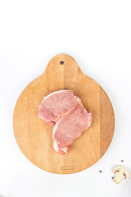 Tenderloin fillet mignon on kitchen cutting board with ingredients for cooking