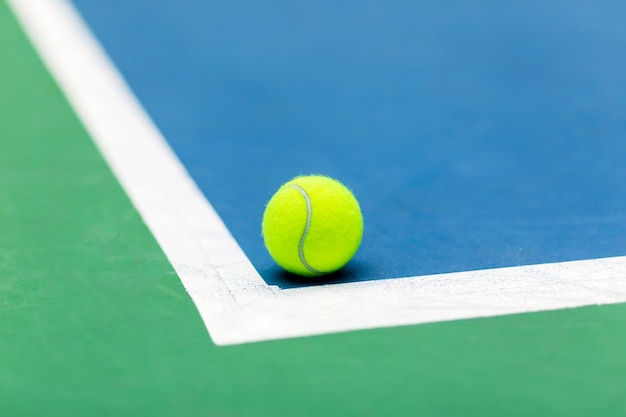 Tennis Ball on a Court Near the Baseline