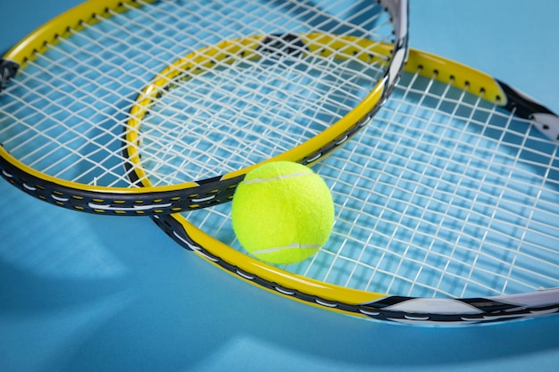 Tennis ball and rackets on the blue background