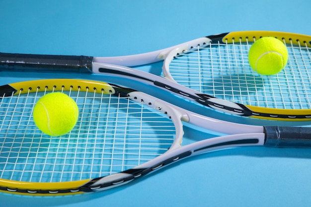 Tennis ball and rackets on the blue background