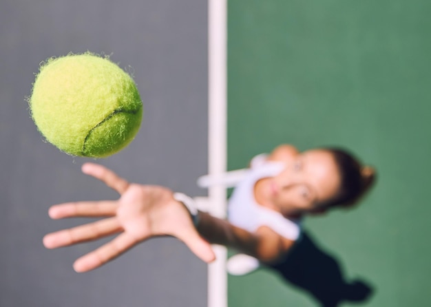 Tennis ball sports and female player throwing and serving on a court outside from above Athletic woman playing game for competitive fun with copy space Sporty woman preparing for a game