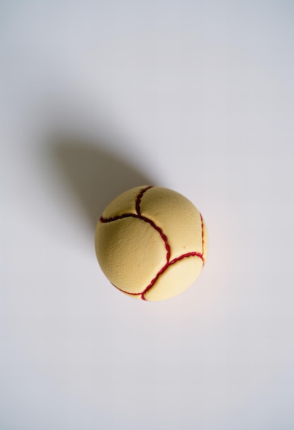 Photo a tennis ball with a red line on it is shown