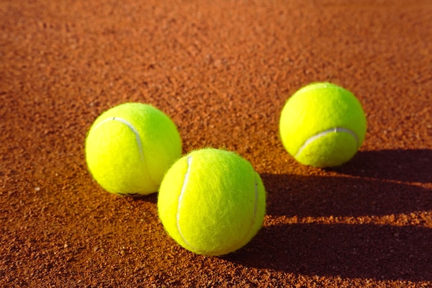 Tennis balls on a clay court training Sunny summer